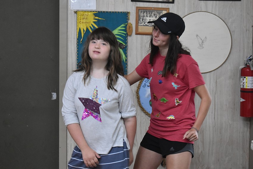 Tampa's Julia Frye, 12, and camp counselor Allie Lowery from Tara dance to music while playing Four Corners. Frye said her favorite part of camp was spending time by the campfire.