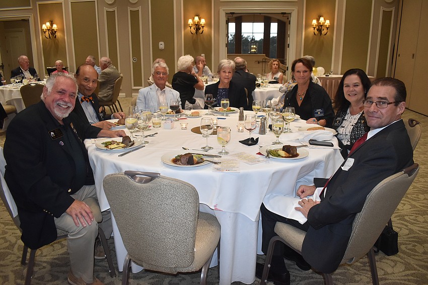 Ken Kaplan, Govind Singh, Paolo Tricase, Susan Hubbell, Vana Prewitt, Christi Villalobos and Greg Villalobos share a dinner table. Kaplan, Hubbell and Christi Villalobos all received awards.