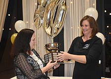 Christi Villalobos receives the Stephen Garber Award from President Laura Adcock. Villalobos also received the Rotarian of the Year Award.