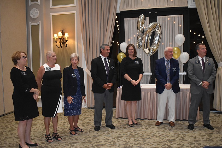 Directors Sybil Porter, Joyce Borda, Susan Hubbell, Treasurer James Wingert, Immediate Past President Laura Adcock, Vice President Carmen Spagnola and President Mark Midyett stand together after being inducted to new positions.