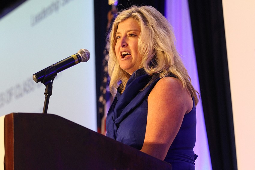 Chamber president and CEO Heather Kasten announces the award presenters to the stage.