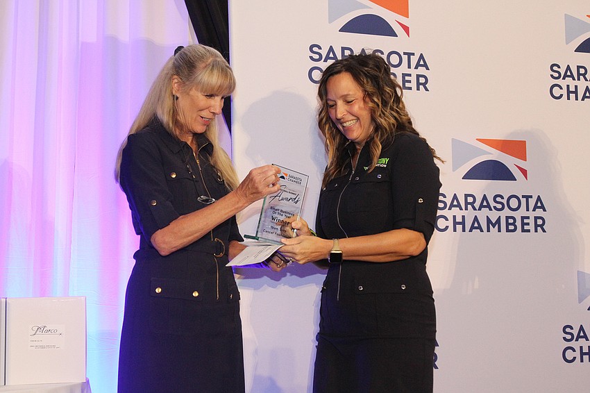 Anita Eldridge gives the Small Business Award to Executive Director Kelly Deam with Team Tony Cancer Foundation.