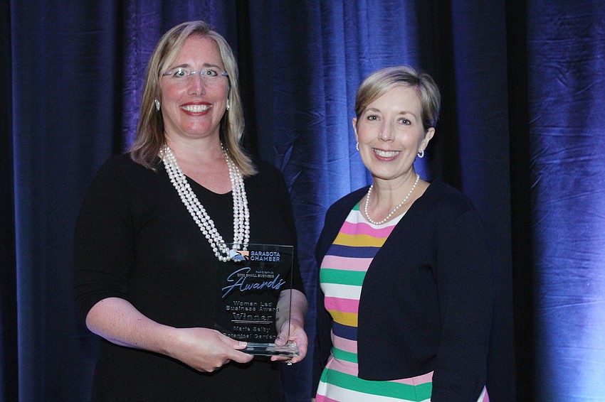 Jennifer Rominiecki and Wendy Deming of Marie Selby Botanical Gardens pick up the Women-Led Business Award.
