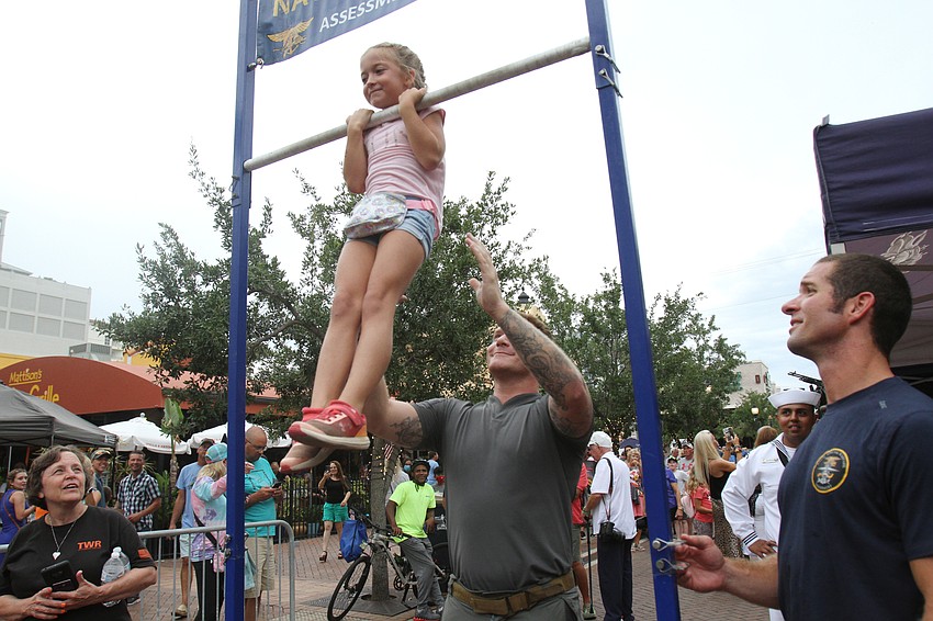 Khloe Drymon does as many chin ups as she can.