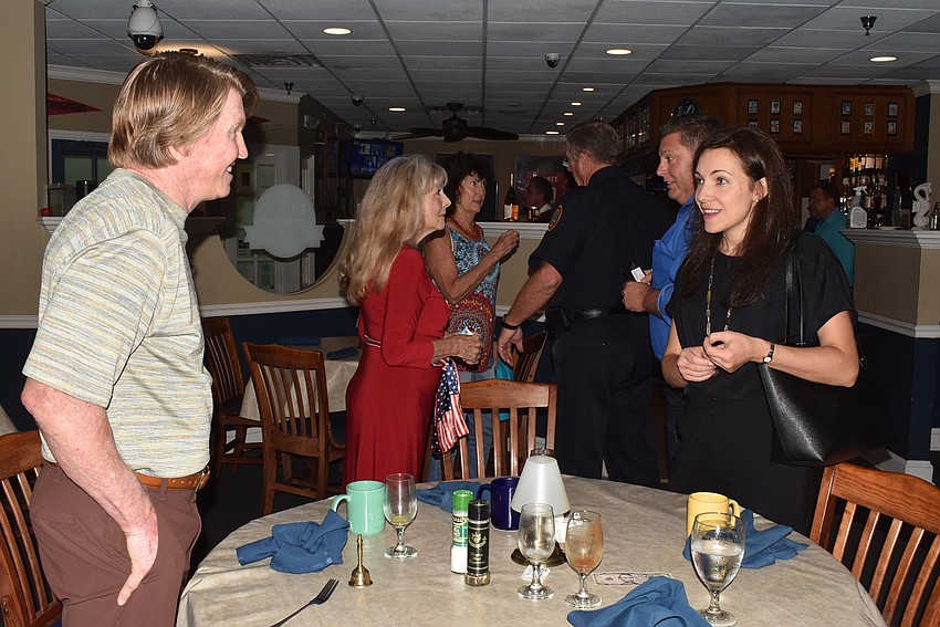 Attendees mingled after the meeting dispersed.