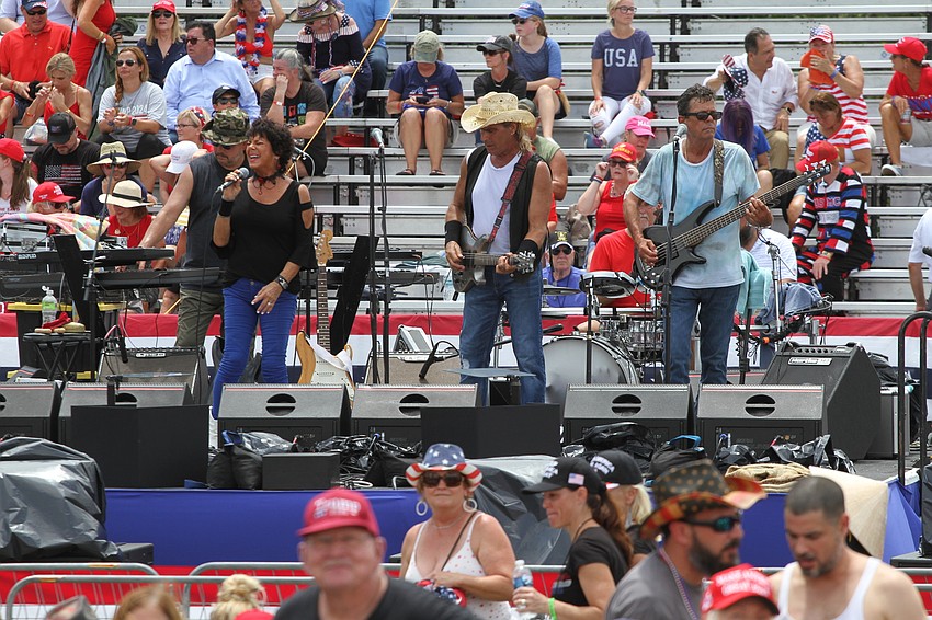 The arriving audience listens to live music.