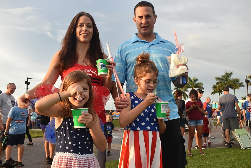 Sarasota's Cassidy Bembaron, Serena Bembaron, 6, John Bembaron and Brianna Bembaron, 9, enjoy frozen treats. They almost went home during an hourlong downpour, but they were glad they stayed.