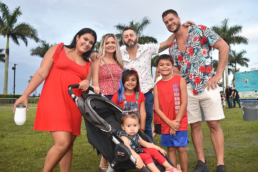 Sarasota's Logan Fonseca, Marissa Smith, Alex Smith, Sophia Smith, 8, Sasha Smith, 2, Graison Kilduff, 8, and Joshua Kilduff enjoy the enthusiastic atmosphere they found at Fireworks On the Lake.