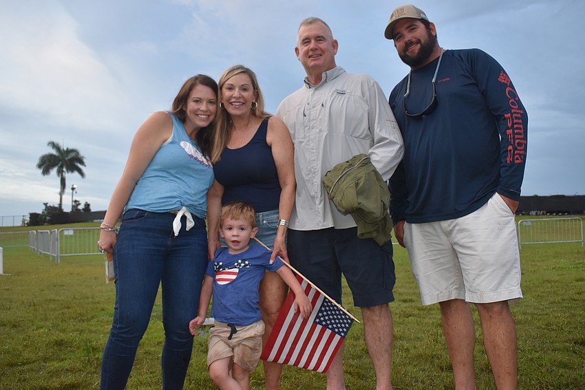 Bradenton residents Brittany and Banks Gregory, 2, Tara residents Trudi and Mac Gregory, and Bradenton resident Colby Gregory smile after watching Banks take several trips down the inflatable slide in the Kids Zone.