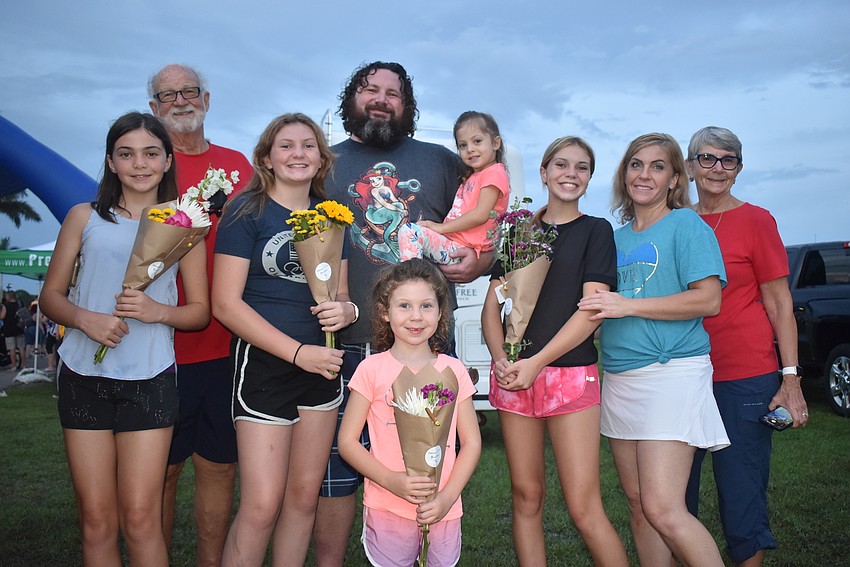 Greenbrook's Adelynn Harris, 11, Greg Harris, Aubrey Harris, 14, Justin Harris, Aurora Harris, 4, Amelia Harris, 6, Amayah Hayden, Kelly Harris and Mary Harris buy flowers from Sweet B's Flower Truck.