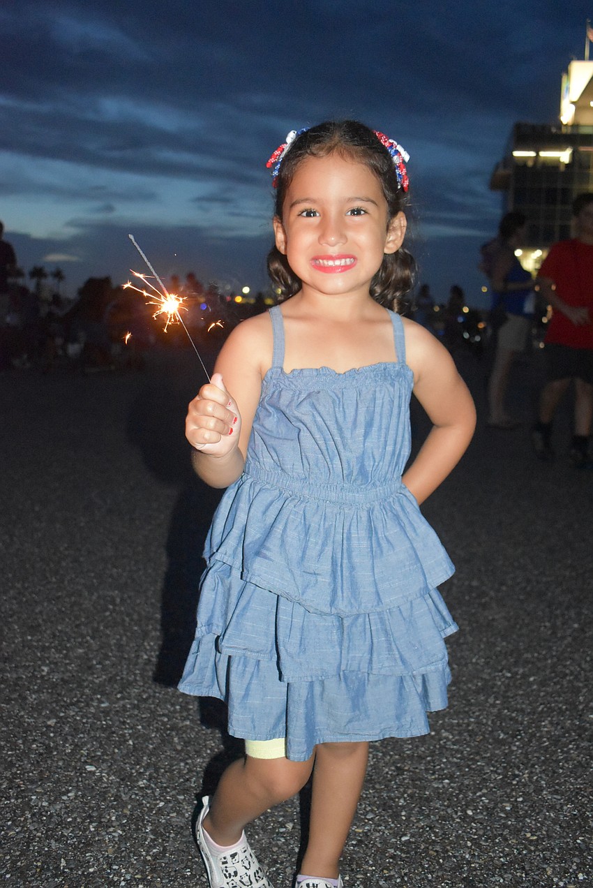 Sarasota's Abriana Navarro, 4, plays with a sparkler just minutes before the fireworks show began.