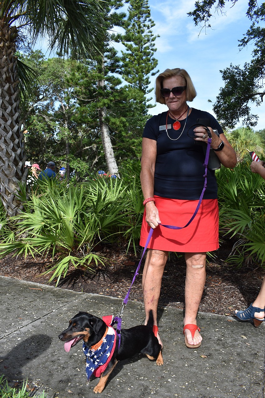 At-Large Commissioner BJ Bishop and her dog pose for a picture after marching in the Freedom Fest parade.