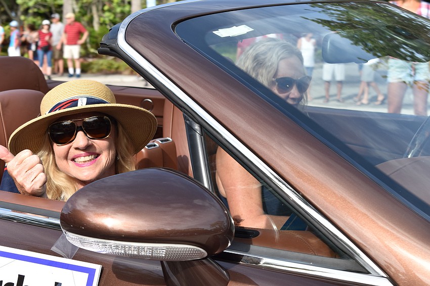 Dr. Colleen Healy waved during Sunday's Freedom Fest parade. Healy served as one of the parade's grand marshals.