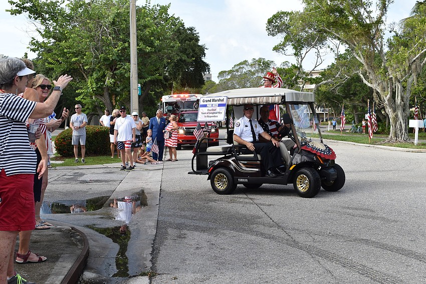 Fire Chief Paul Dezzi and Town Manager Tom Harmer waved during Sunday's Freedom Fest parade. Dezzi served as one of the parade's grand marshals.