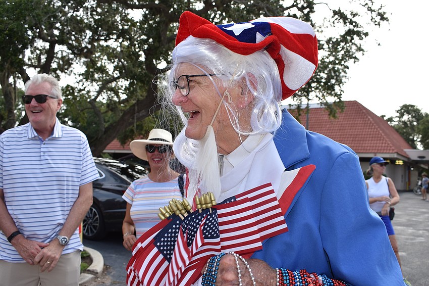 Jim Seaton dressed as Uncle Sam and handed out American flags and beads at the Freedom Fest parade.