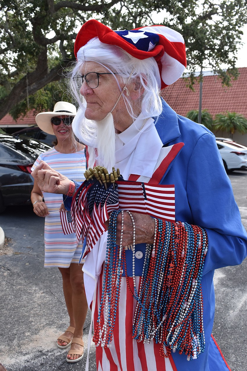 Jim Seaton dressed as Uncle Sam and handed out American flags and beads at the Freedom Fest parade.