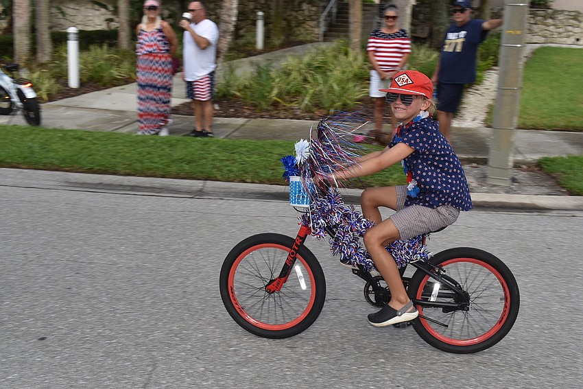 Cannon Creech rides his decorated bike down the street before the parade.