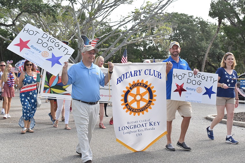 Brad Marner and Bo Fuller hold the Rotary Club's banner and lead the Hot Diggity Dog! section.