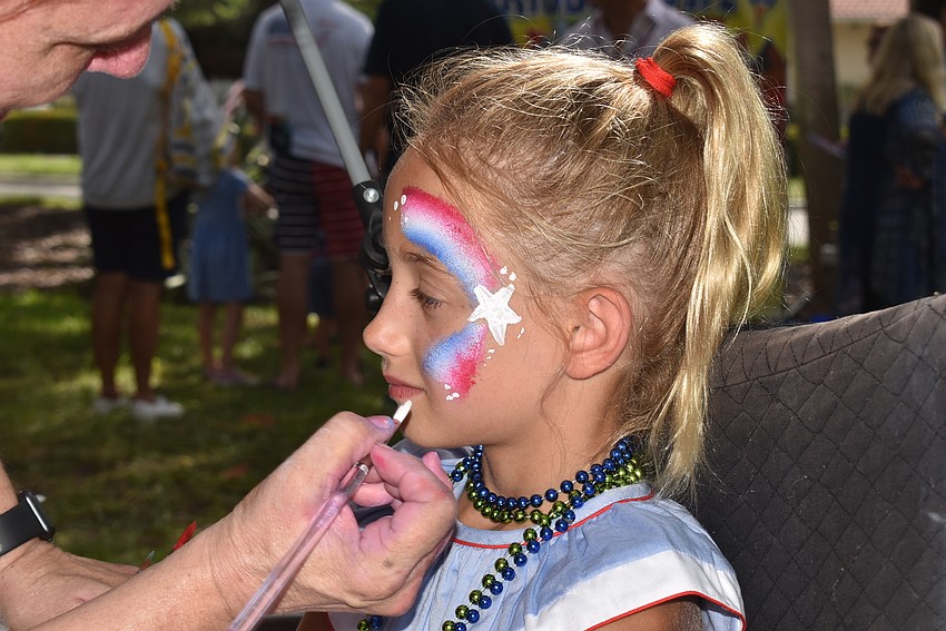 Mary Ellen Forshey gets her face painted.