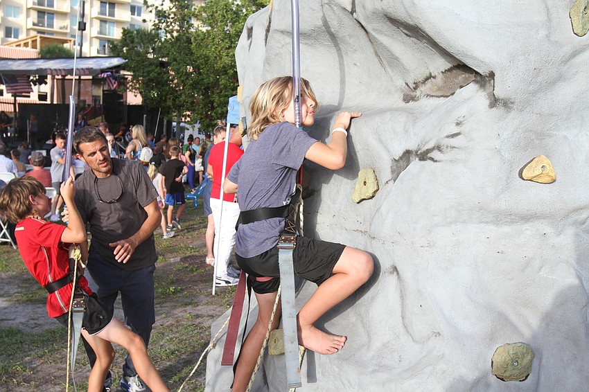 Kowen Hartter climbs the rock wall.
