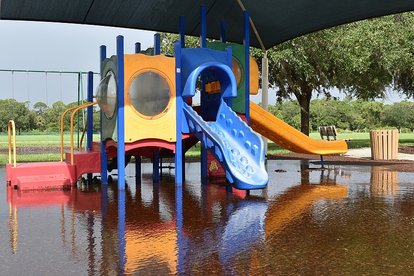 Water pools underneath the playground Wednesday morning at Greenbrook Adventure Park in Lakewood Ranch. Photo by Brendan Lavell