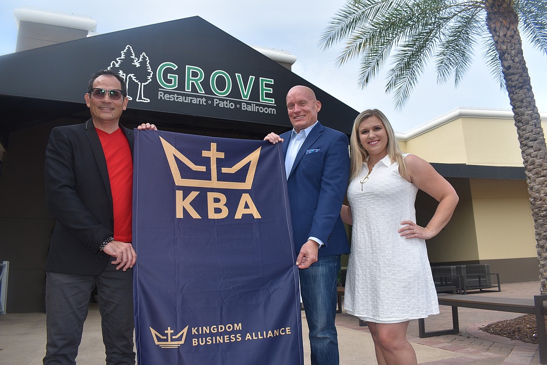 Kingdom Business Alliance Co-founders Greg Claxton and Scott McKay stand with member Mindy Poff after a Tuesday morning meeting at the Grove. The alliance meets every single week.