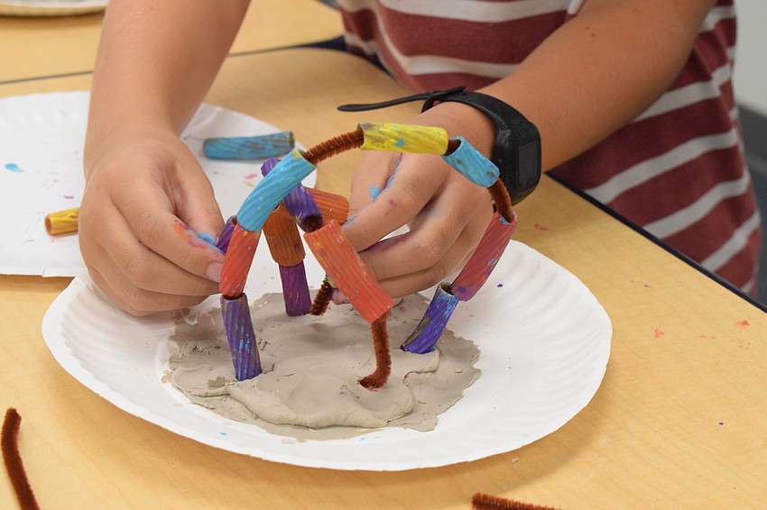 Blake Rattigan puts the final touches on his coral reef.