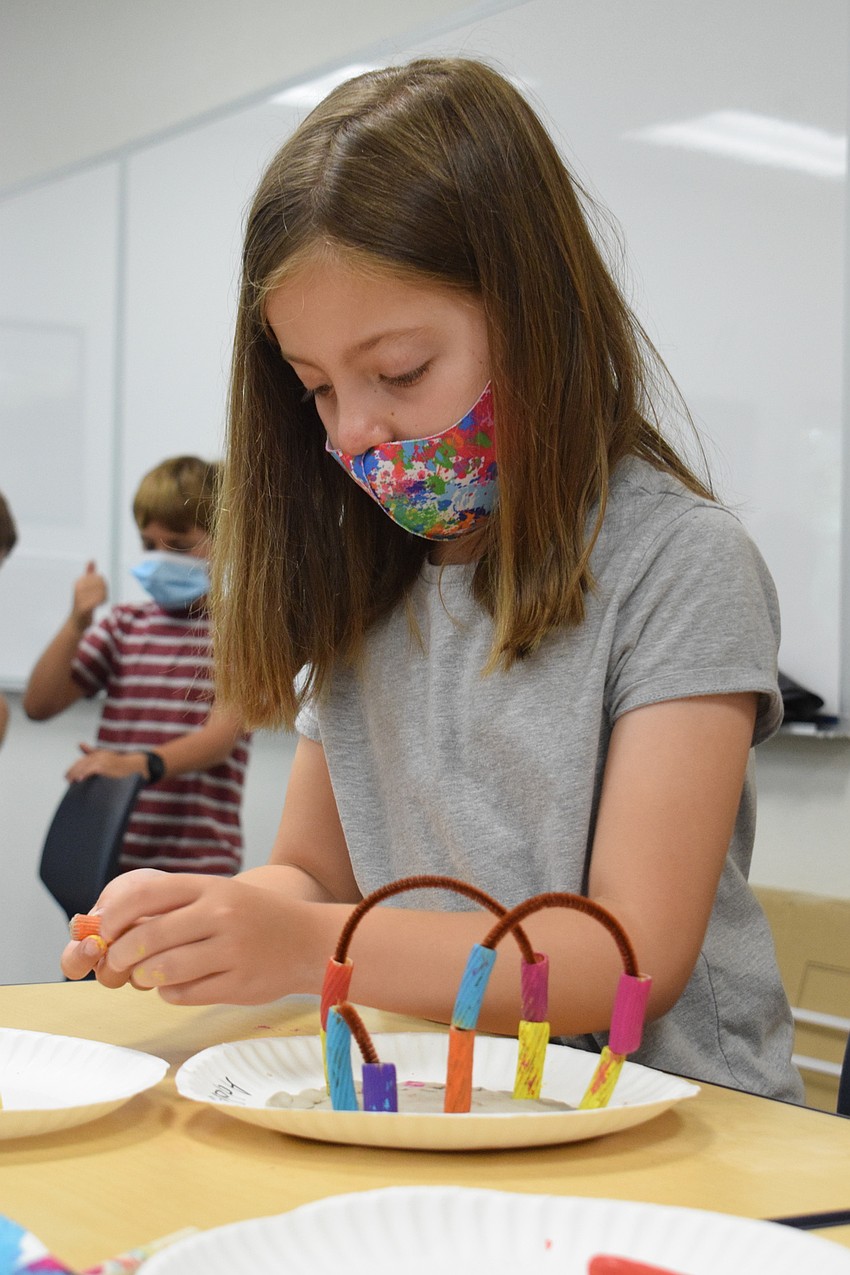 Addison Dooley enjoys making her coral reef, which is just one of the activities schedule for the week's under the sea theme. 