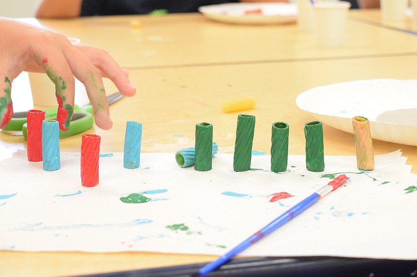 Noodles dry before being places on a pipe cleaner.