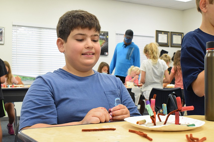 Antonio Maio is pleased with the work he's done on his coral reef so far before going back to add more noodles.