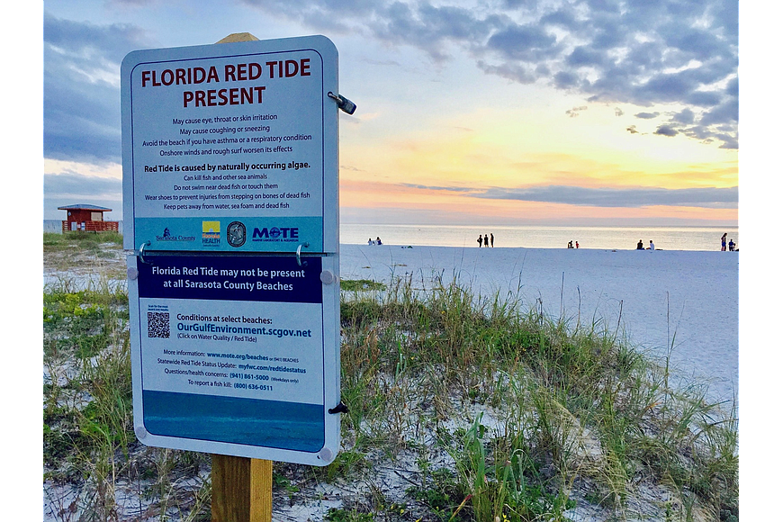 The county is posting signage alerting beachgoers about the elevated levels of red tide detected in the water. File image.