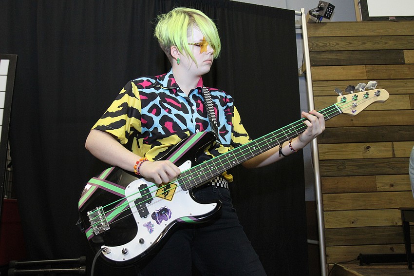 Kat Maly, 15, rocks out to the side of the stage.