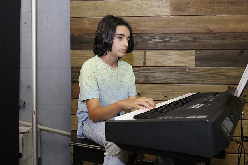 Yonatan Lardin, 14, adds to the ensemble with the keyboard.