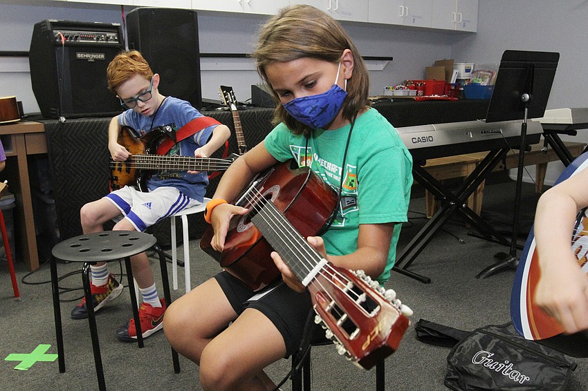 Eli Reynolds, 9, and Riley Jimenez, 8, work on their music.