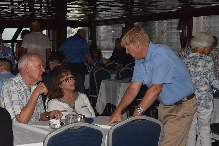 Bob and Vanda Soper chat with Tom Potthast onboard the boat.