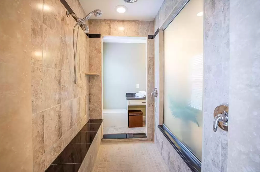 The first home for sale features a large walk-in shower.