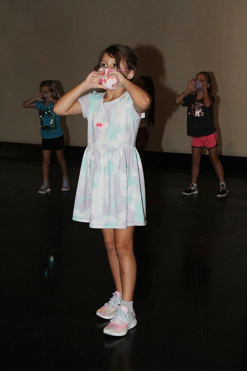 Lily Karbid dances along.