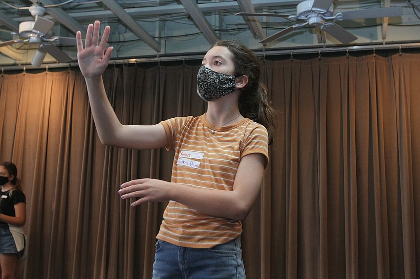 Emma Smith imagines herself holding an object during an acting exercise.