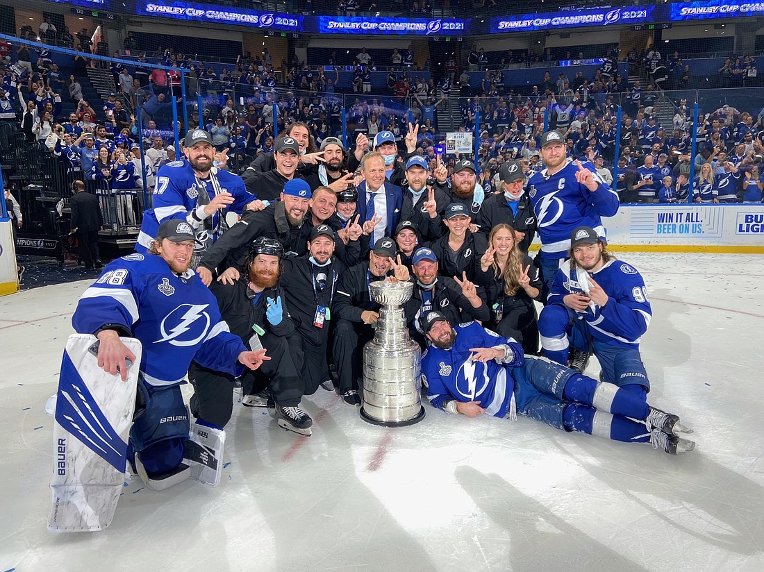 Lakewood Ranch&#39;s Ali Murdock, sandwiched to the left of Lightning Coach Jon Cooper, got a picture of herself and her fellow ice crew members with the Stanley Cup after Tampa&#39;s win. Courtesy photo.