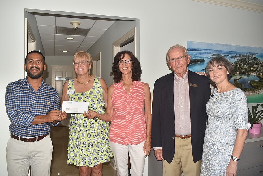Diego Velasco, Brenda Zofrea and Peg Hughes from Visible Men Academy with Bill Anderson, who nominated the organization, and Sharon Gould.