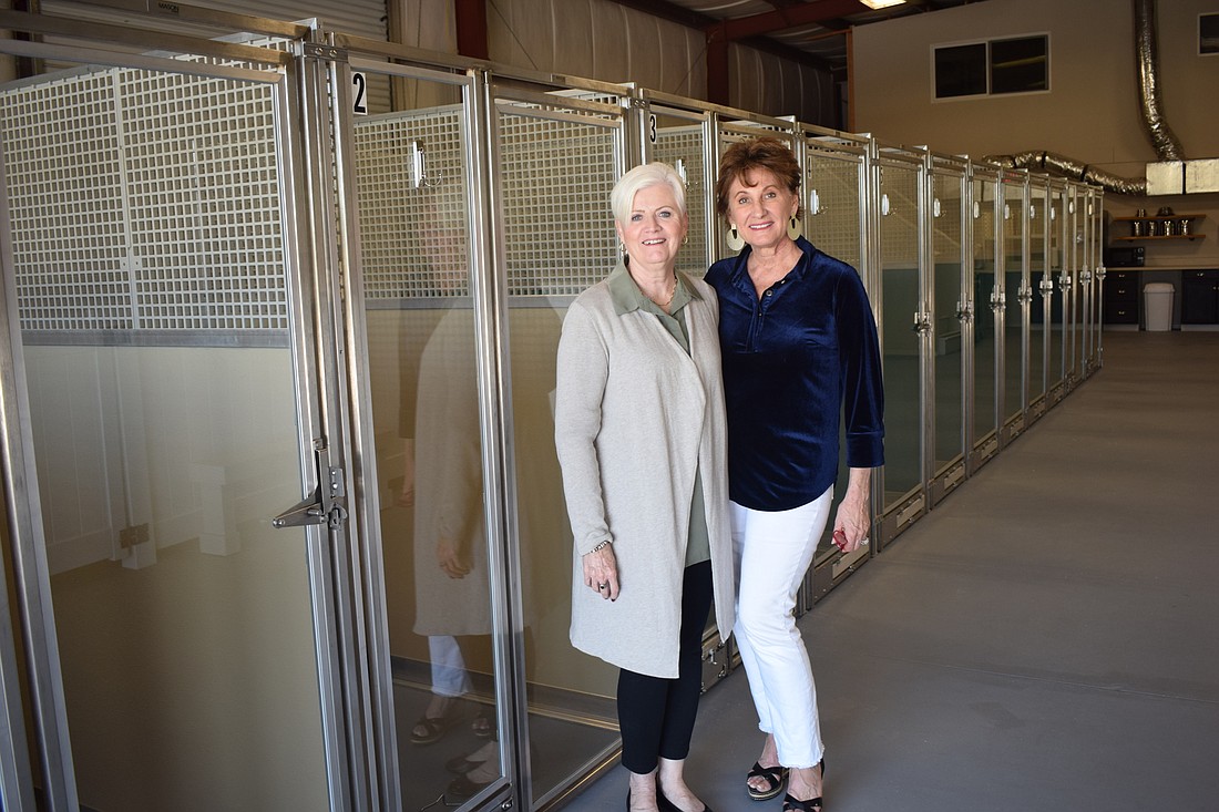 Deanna Murchie and Susan Giroux show the new dog kennels they have added to their Humane Society of Lakewood Ranch site in Myakka City. Could the county benefit from a public-private partnership with the nonprofit?