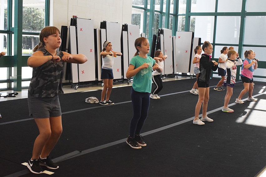 Campers Vivian Fawcett, Ava Clementi and Avionna Twyford practice their dance routine alongside other campers.