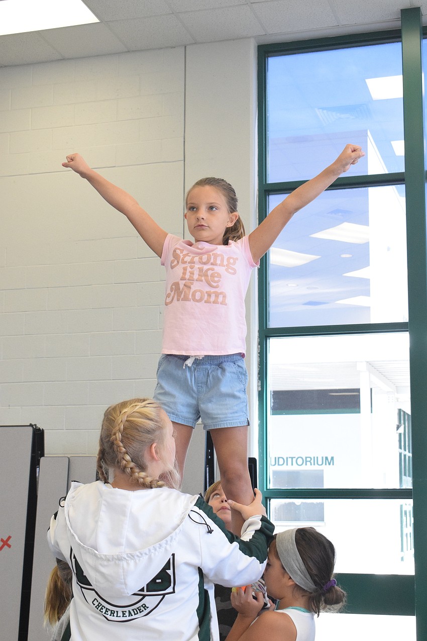 Avery Snodgrass, who is 9, says she likes being a flyer because she gets to go high in the air.