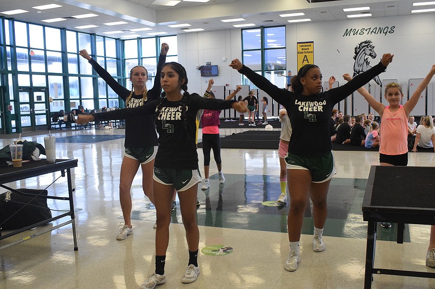 Lakewood Ranch High School JV cheerleaders Chloe Wetherington, Juliarose Lopez and Rakaila Ross go through the motions of a cheer to demonstrate it to the campers.