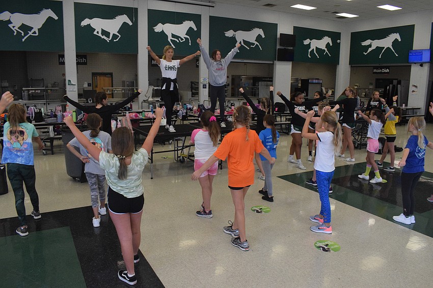 Lakewood Ranch High School cheerleaders lead campers in a cheer.