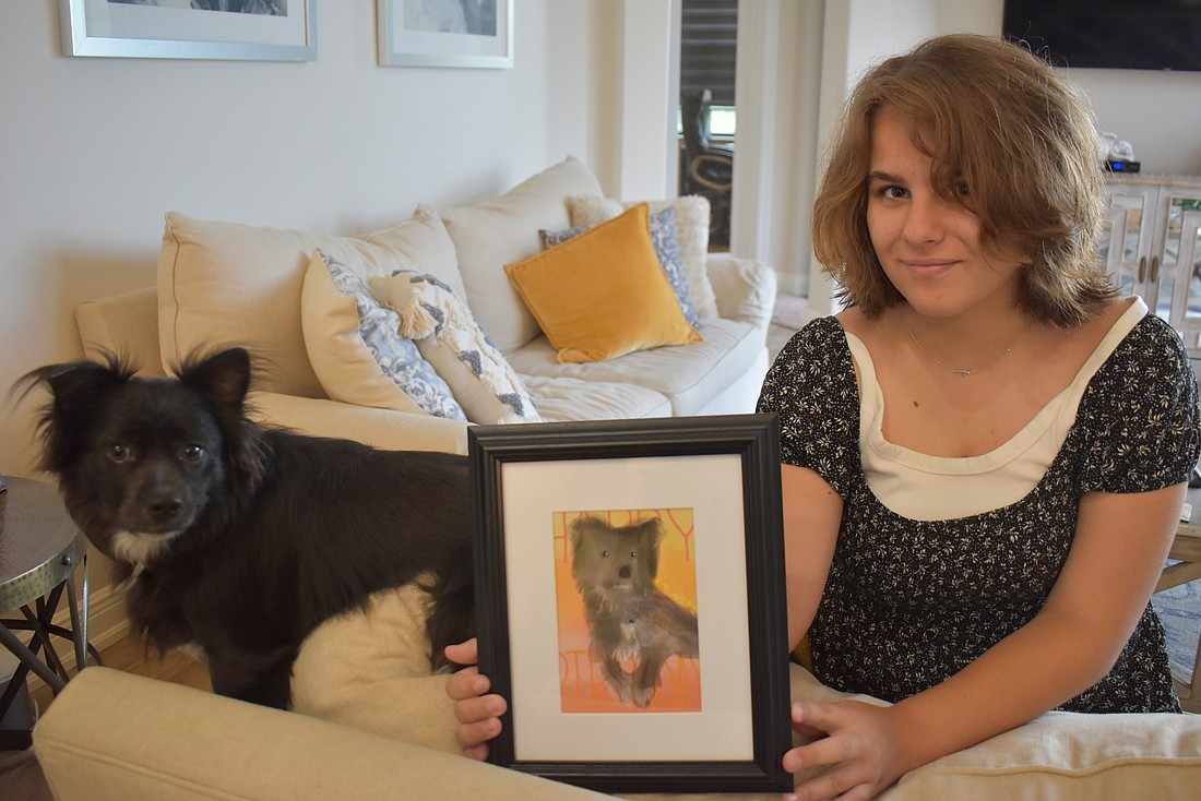 Francesa Bisordi, 12, sits with her dog, Monty, who she drew for her mother&#39;s birthday. Bisordi&#39;s mom loves sunsets, which is why she chose a sunset-shaded background for her drawing.