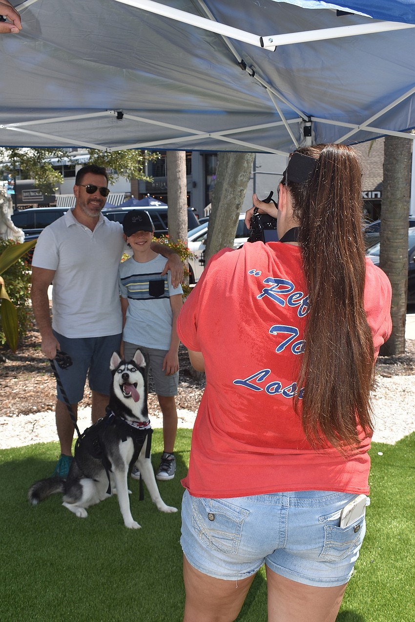 Rachel Merritt snaps a photo of Brian and Logan Chapman with dog Meka.