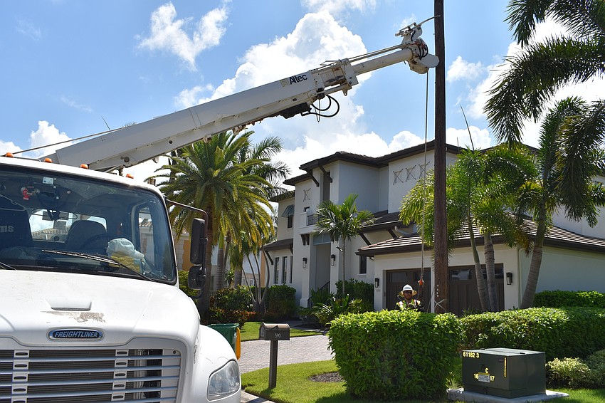 On July 22, Volt Power Co. crews worked to remove light poles from Birdie Lane. Groudman Jared Truxillo is pictured here at the base of the wooden pole.