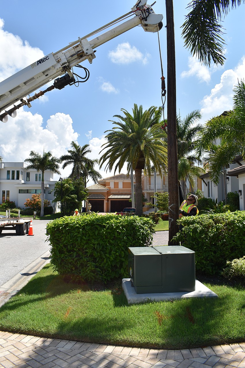 On July 22, Volt Power Co. crews worked to remove light poles from Birdie Lane. Groudman Jared Truxillo is pictured here at the base of the wooden pole.