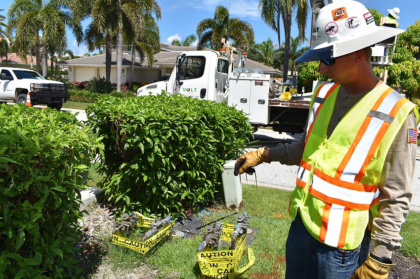 On July 22, Volt Power Co. foreman Jimmy Sasser shows where workers removed a wooden light pole on Birdie Lane.